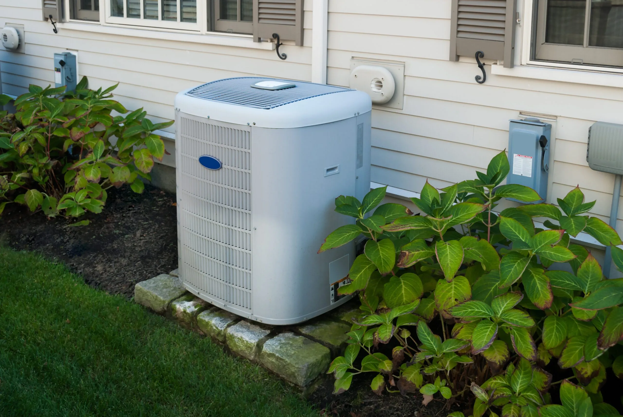 Heating,And,Air,Conditioning,Inverter,On,The,Side,Of,A Heating and air conditioning inverter on the side of a house
